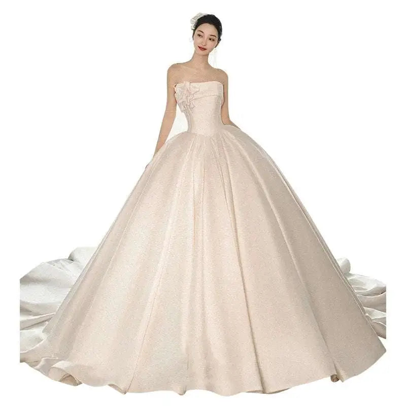 Strapless ivory satin ball gown with fitted bodice embroidered floral appliqué and voluminous glittering skirt luxury women’s fashion