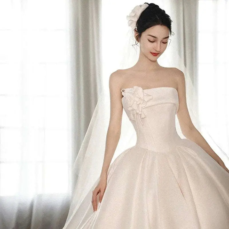 Strapless ivory satin dress with fitted bodice and embroidered floral appliqué featuring a big train luxury women’s fashion