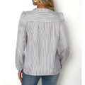 A woman wears a long-sleeved striped fashionable versatile shirt with puffed shoulders and a classic collar