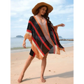 A plus size bikini blouse featuring a vibrant knit poncho with bold diagonal stripes in black red and orange hues