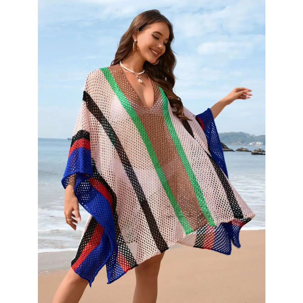 A plus size bikini striped loose plus mesh poncho with bold vertical stripes in green blue red and black on beige