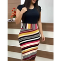 A woman models a striped printed office midi pencil dress with bold horizontal stripes and a navy blue top