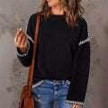 Black round neck pullover knit sweater with white striped accents on sleeves and hem for casual wear