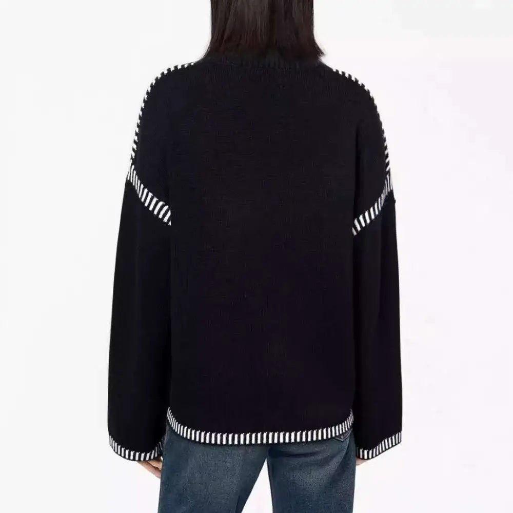 Black round neck pullover knit sweater with white striped accents on sleeves and hem in pullover knit sweater style