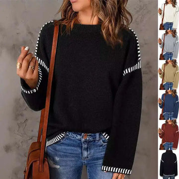 Black round neck pullover knit sweater with white striped accents on sleeves and hem in pullover knit sweater style