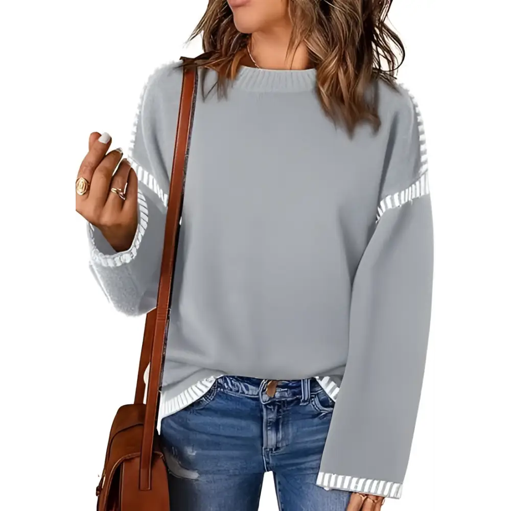 Gray knit round neck pullover knit sweater with white striped cuffs and shoulder accents for casual wear