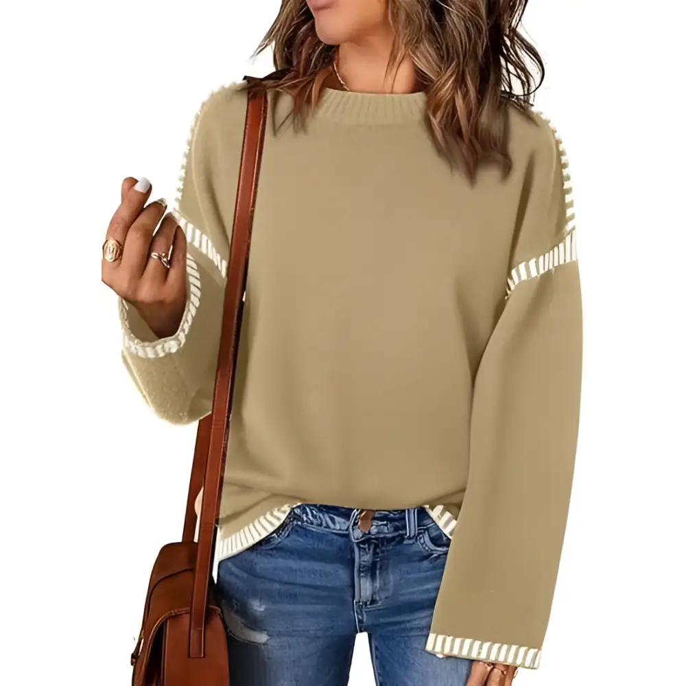 Beige knit pullover knit sweater with white ribbed trim on sleeves and hem featuring a round neck pullover design