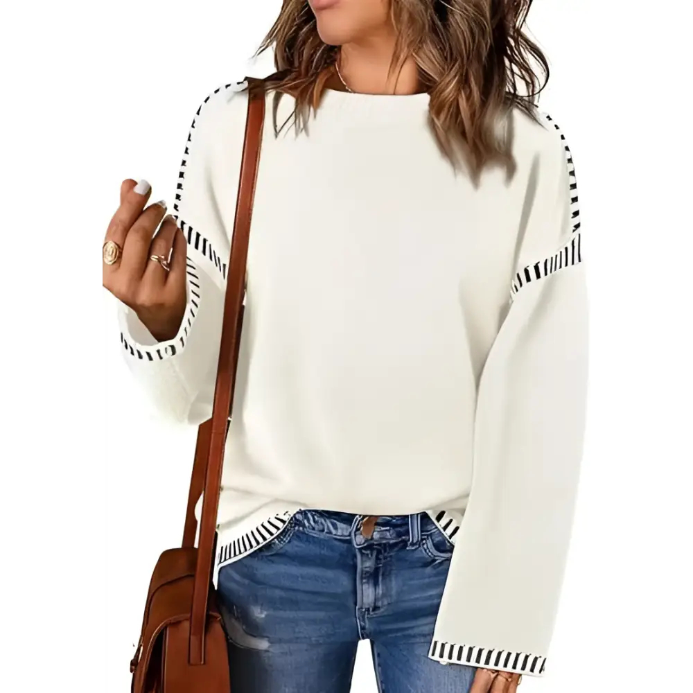 Off-white round neck pullover knit sweater with black and white striped trim along sleeves and hem