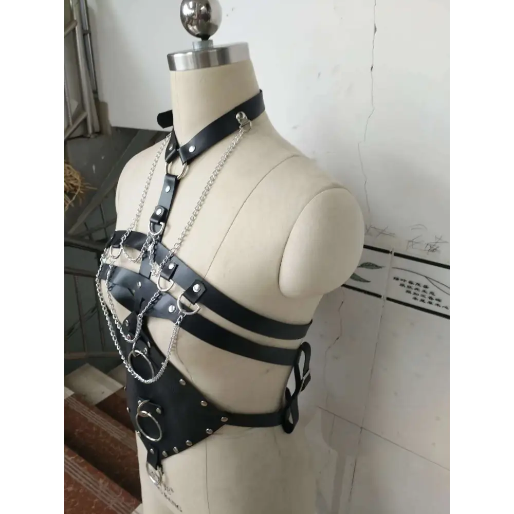 Black leather studded leather harness adorned with silver studs and chains for harness perform dance costume use