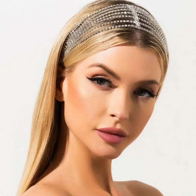 A sparkling silver layered rhinestone headband with a black elastic band and sleek princess elastic multi design