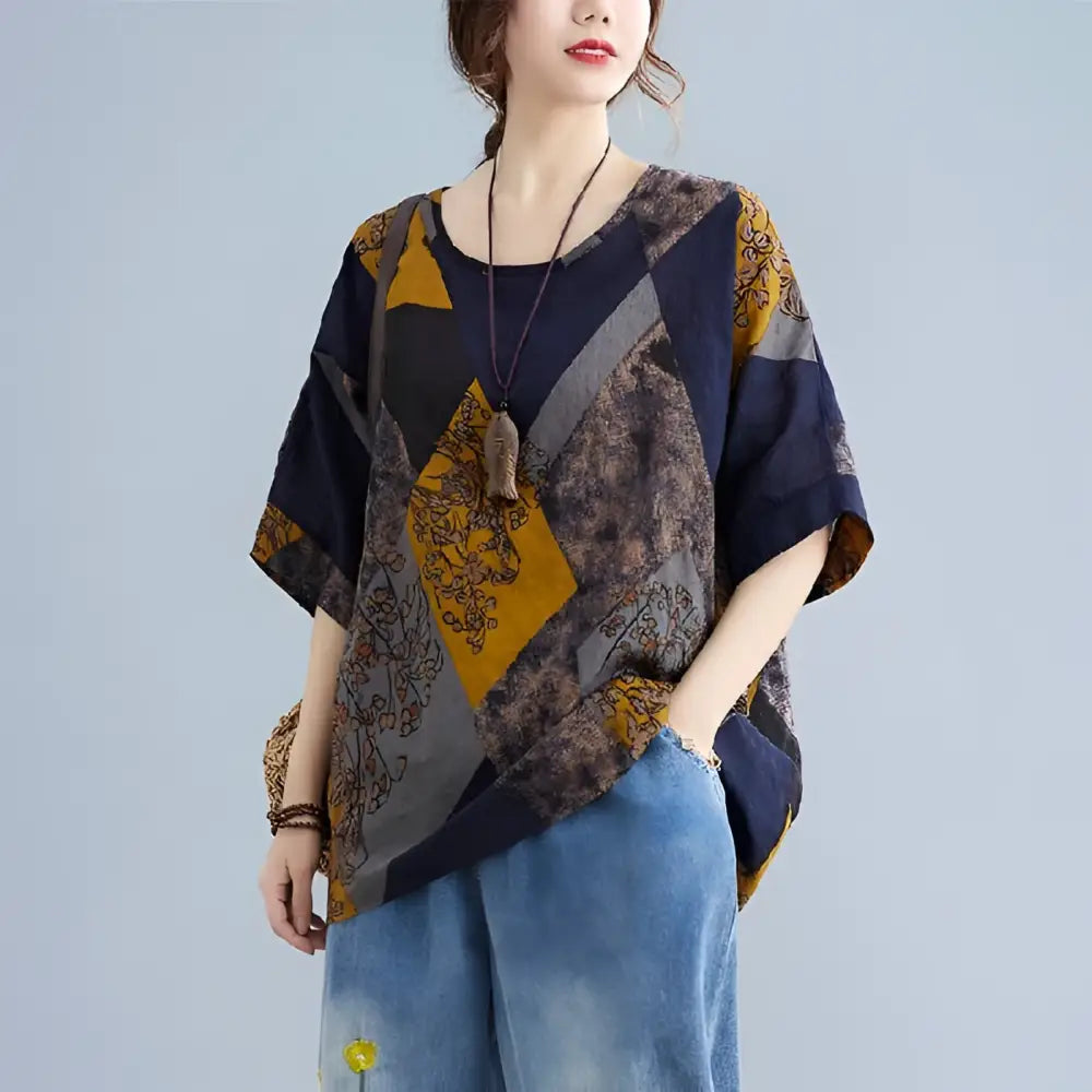 Stylish loose round neck printed patchwork blouse with geometric panels in navy blue mustard yellow and gray floral embroidery