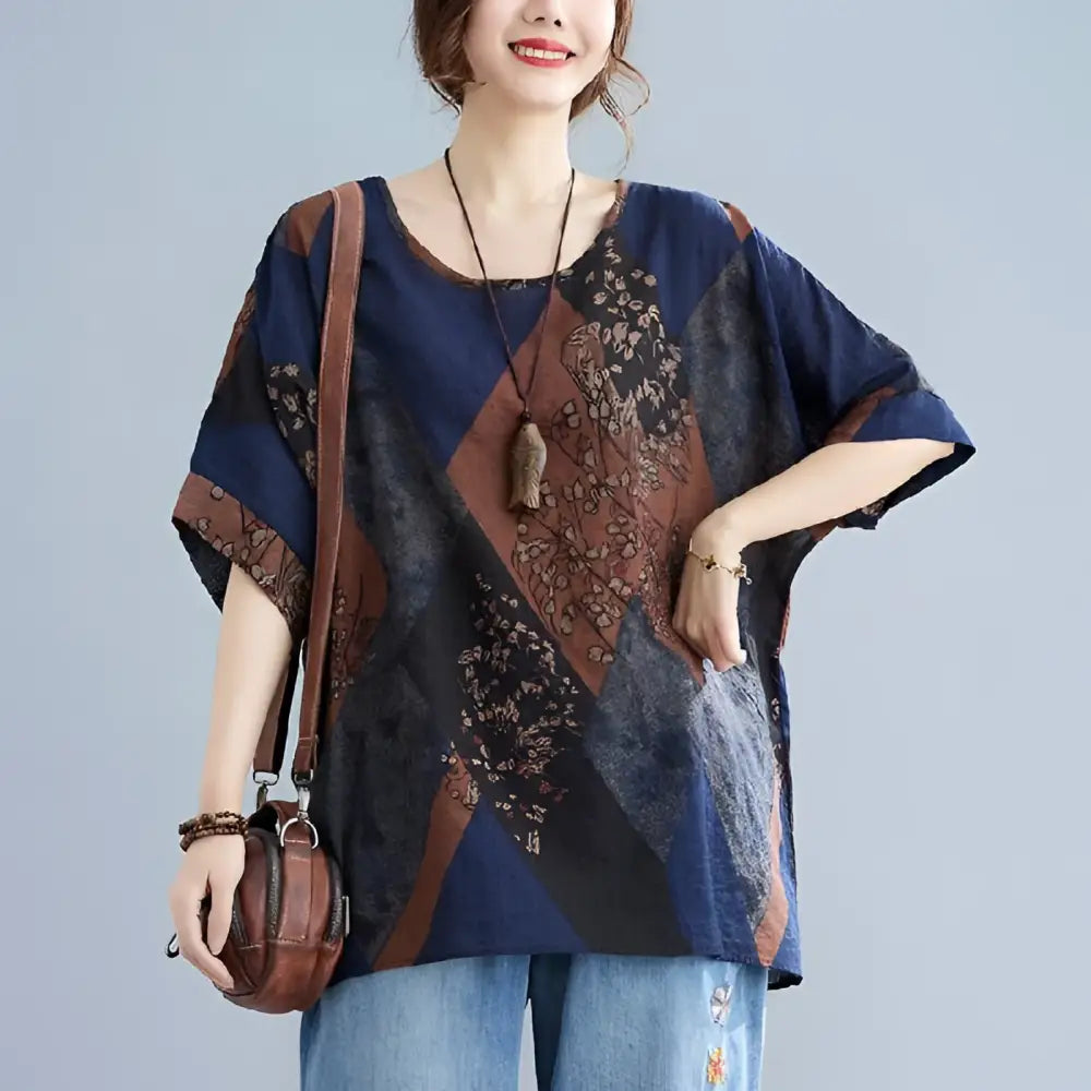 Stylish loose round neck printed patchwork blouse in navy blue and brown with floral geometric panels in earthy tones