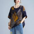 Stylish loose round neck printed patchwork blouse with navy, mustard, and gray geometric panels and floral embroidery