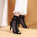 Stylish peep toe black high-heeled ankle booties with hollow mesh design and lace-up detail for dance heels