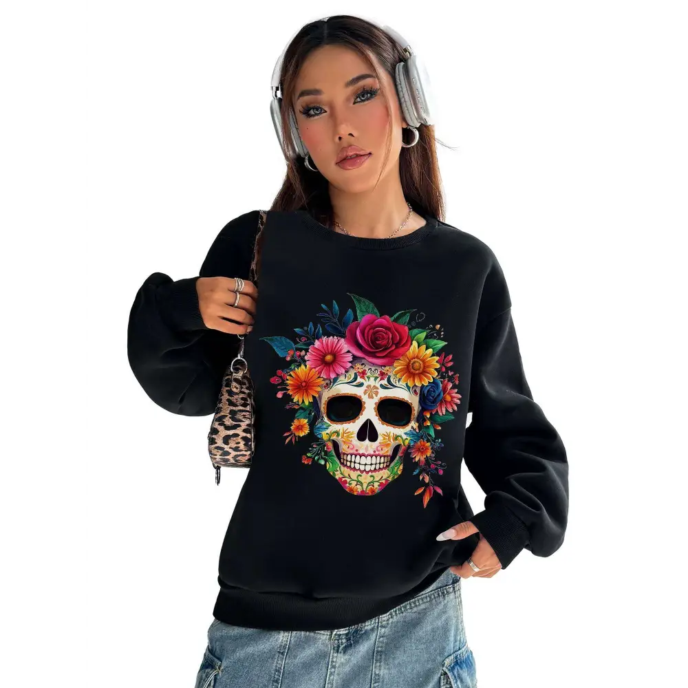 Black crew neck sweatshirt with vibrant colorful floral skull sugar skull design adorned with flowers and foliage