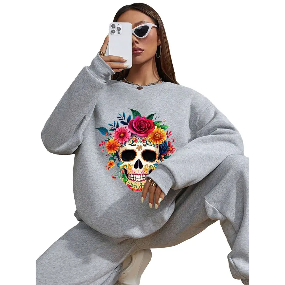 Gray crew neck sweatshirt featuring a vibrant colorful floral skull design for daily wear