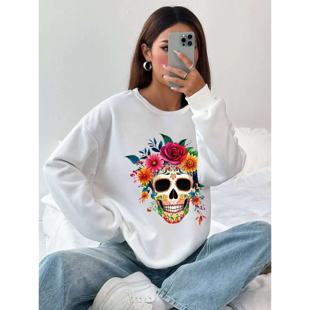 White long-sleeved crew neck sweatshirt with a vibrant colorful floral skull design for daily wear
