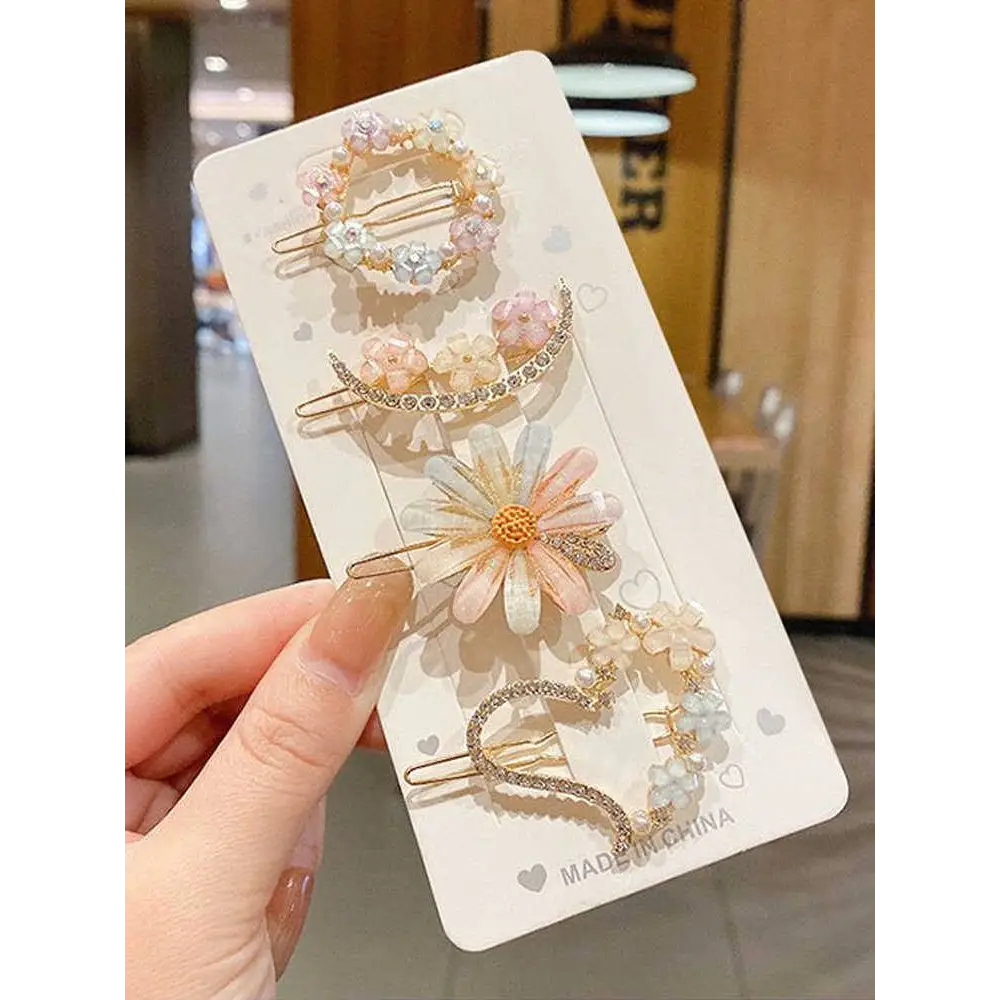 A set of five pastel pink alloy handmade petal hair clips with sparkling rhinestones and pearl accents for summer style