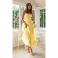 A flowing yellow summer suspender spaghetti strap lace midi dress with ruffled layers and delicate black straps