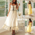 A flowing off-white summer suspender spaghetti strap lace midi dress with delicate black lace trim and corset-style front tie