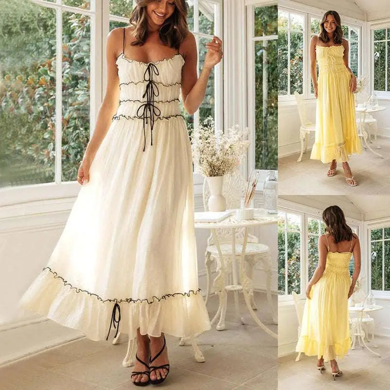 A flowing off-white summer suspender spaghetti strap lace midi dress with delicate black lace trim and corset-style front tie