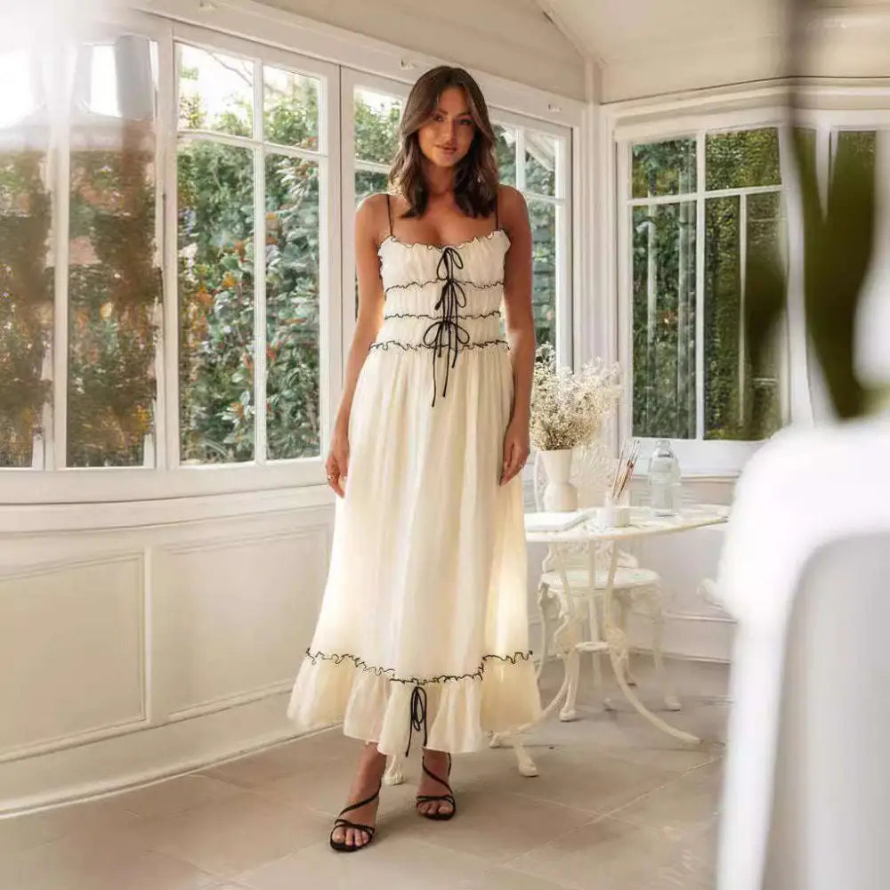 Off-white summer suspender spaghetti strap lace midi dress with delicate black lace-up detailing and ruffled skirt