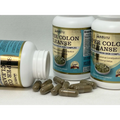 Brown capsules scattered around two white bottles of abuiu super colon cleanse dietary supplement for digestive health