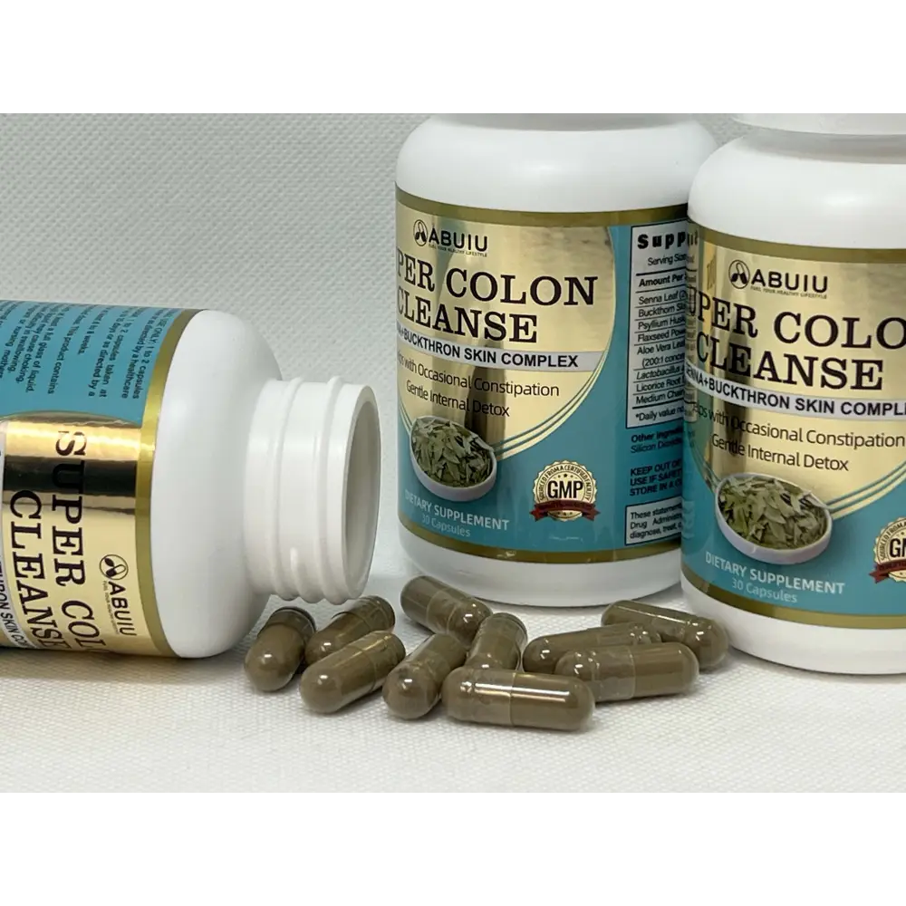 Brown capsules scattered around two white bottles of abuiu super colon cleanse dietary supplement for digestive health