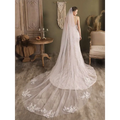 A flowing white lace flower trailing wedding gown with fitted bodice and floral embroidery in super fairy long style