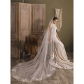 A flowing ivory lace flower trailing wedding veil with delicate floral embroidery on the back for the super fairy long gown