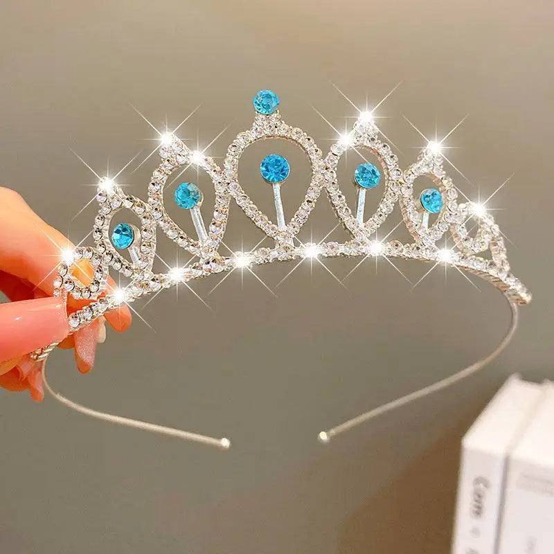 A delicate gold crown headband with clear crystals pearls and pastel butterfly embellishments from sweet fashion jewelry
