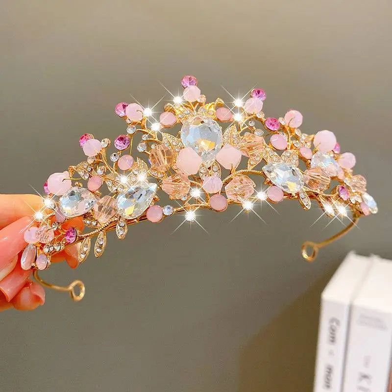 A delicate gold crown headband with sweet fashion jewelry clear crystals and intricate pink floral designs