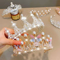 A delicate gold crown headband with clear crystals pearls and pastel butterfly embellishments from sweet fashion jewelry