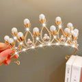 A golden crown headband from sweet fashion jewelry adorned with white pearls and clear crystals rhinestones