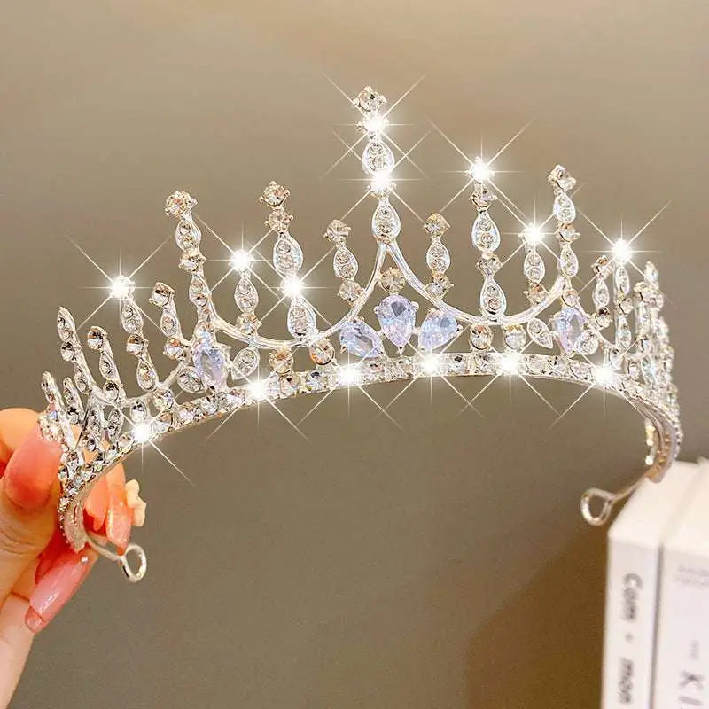 A sparkling silver crown headband with clear crystals and light blue teardrop crystals from sweet fashion jewelry