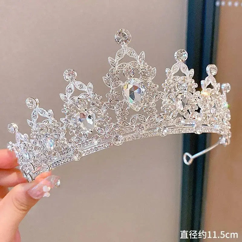 A sparkling silver sweet fashion jewelry crown headband with clear crystals and intricate leaf and floral patterns
