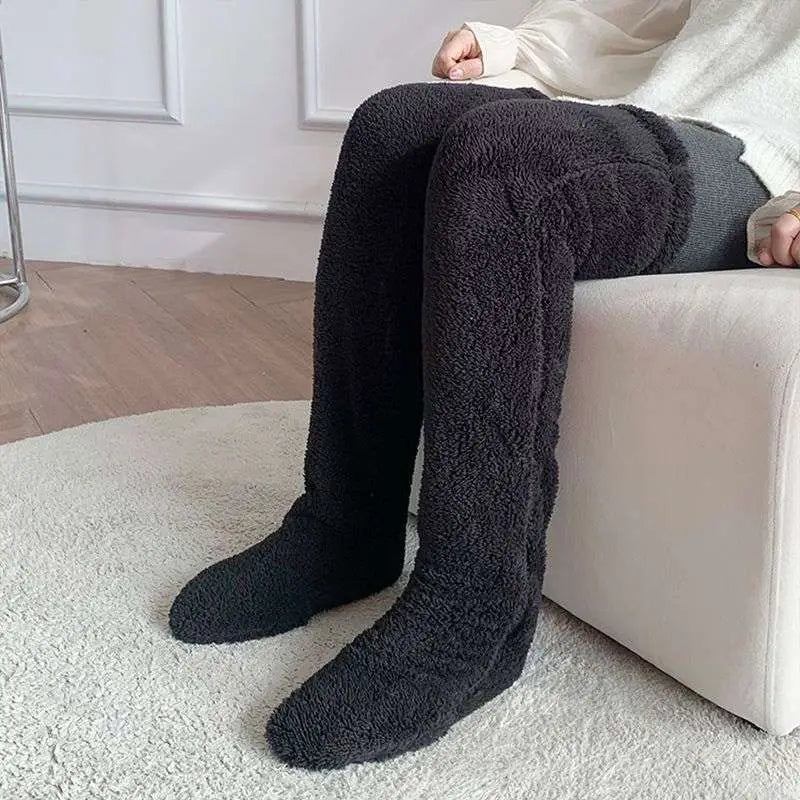 Black plush over-the-knee fuzzy long socks with cozy texture and tan paw print detailing