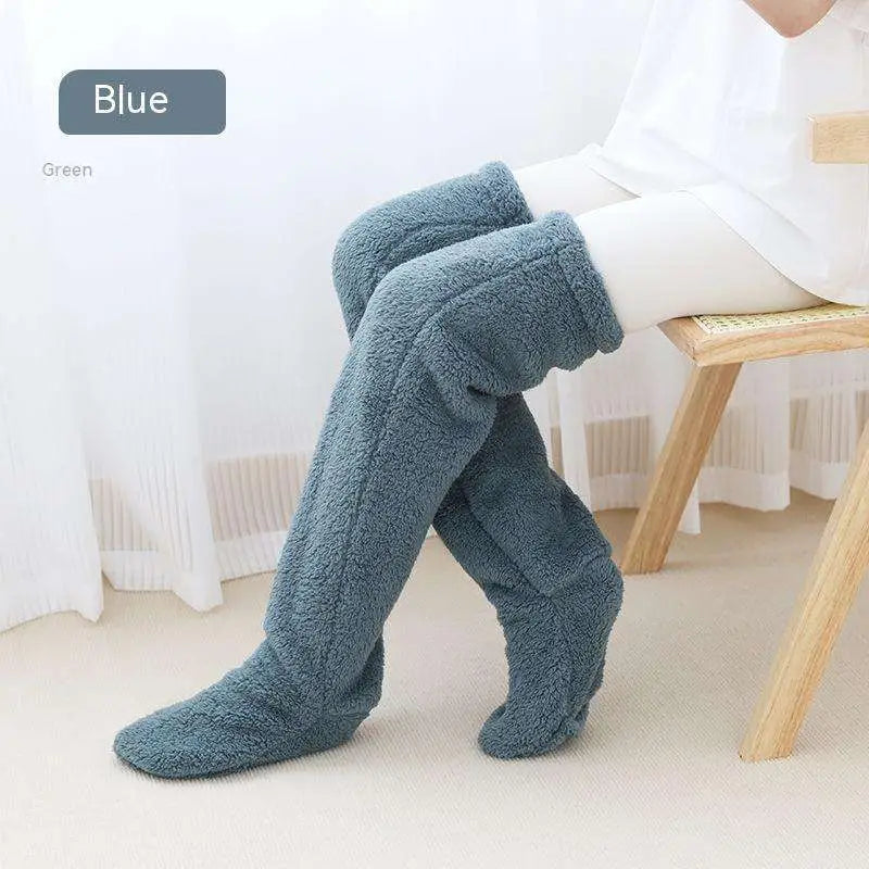Blue plush fleece fuzzy long socks with soft textured surface in tan paw print design for cozy wear