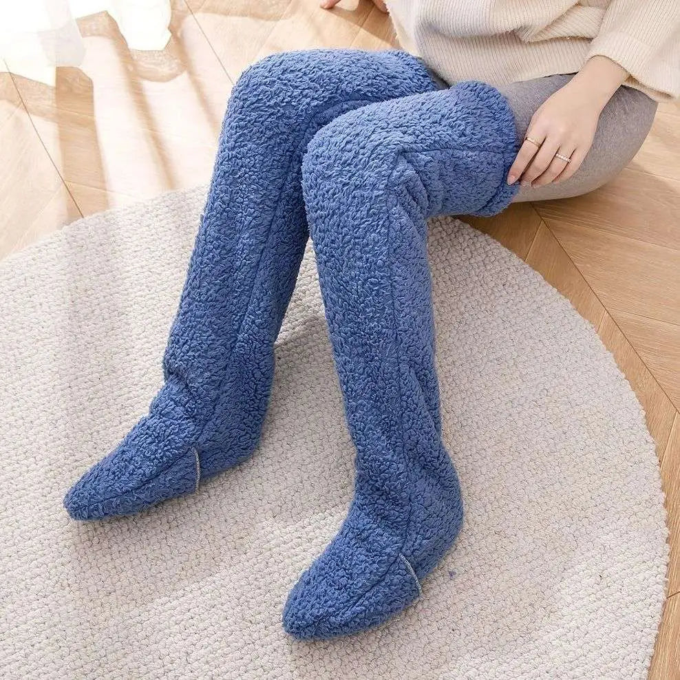 Blue plush over-the-knee leggings made of cozy textured fleece paired with tan paw print fuzzy long socks
