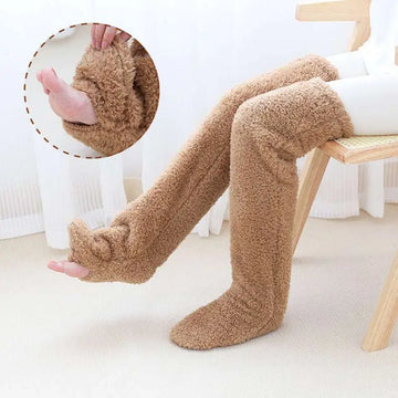 Tan paw print fuzzy long socks featuring tan plush material and paw-like foot design with a soft fuzzy texture