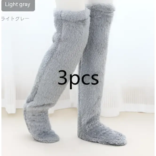 Light gray gray plush fuzzy long socks featuring a tan paw print in a cozy knee-high design