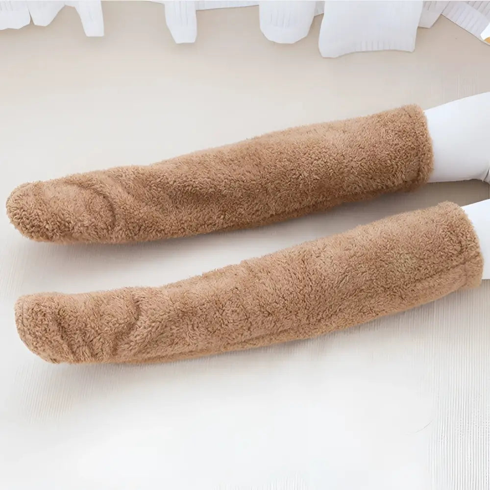 Tan paw print fuzzy long socks made of soft tan plush fleece with a textured surface for cozy warmth