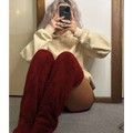 Deep red plush over the knee boots styled with tan paw print fuzzy long socks and gray plush accents