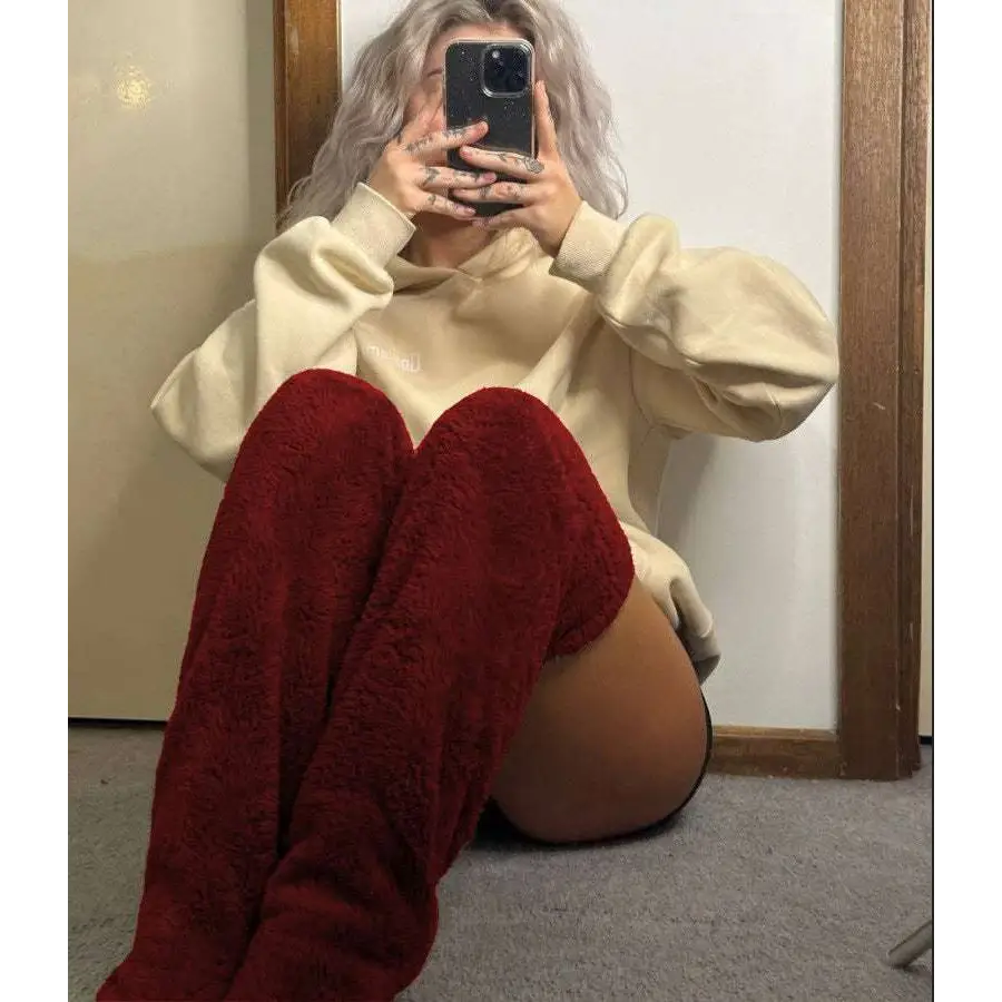 Deep red plush over the knee boots styled with tan paw print fuzzy long socks and gray plush accents