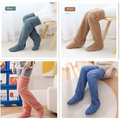 Tan paw print fuzzy long socks in blue brown and peach hues made of soft gray plush over-the-knee slippers