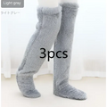 Light gray plush fuzzy long socks with tan paw print detail, designed for cozy knee-high wear