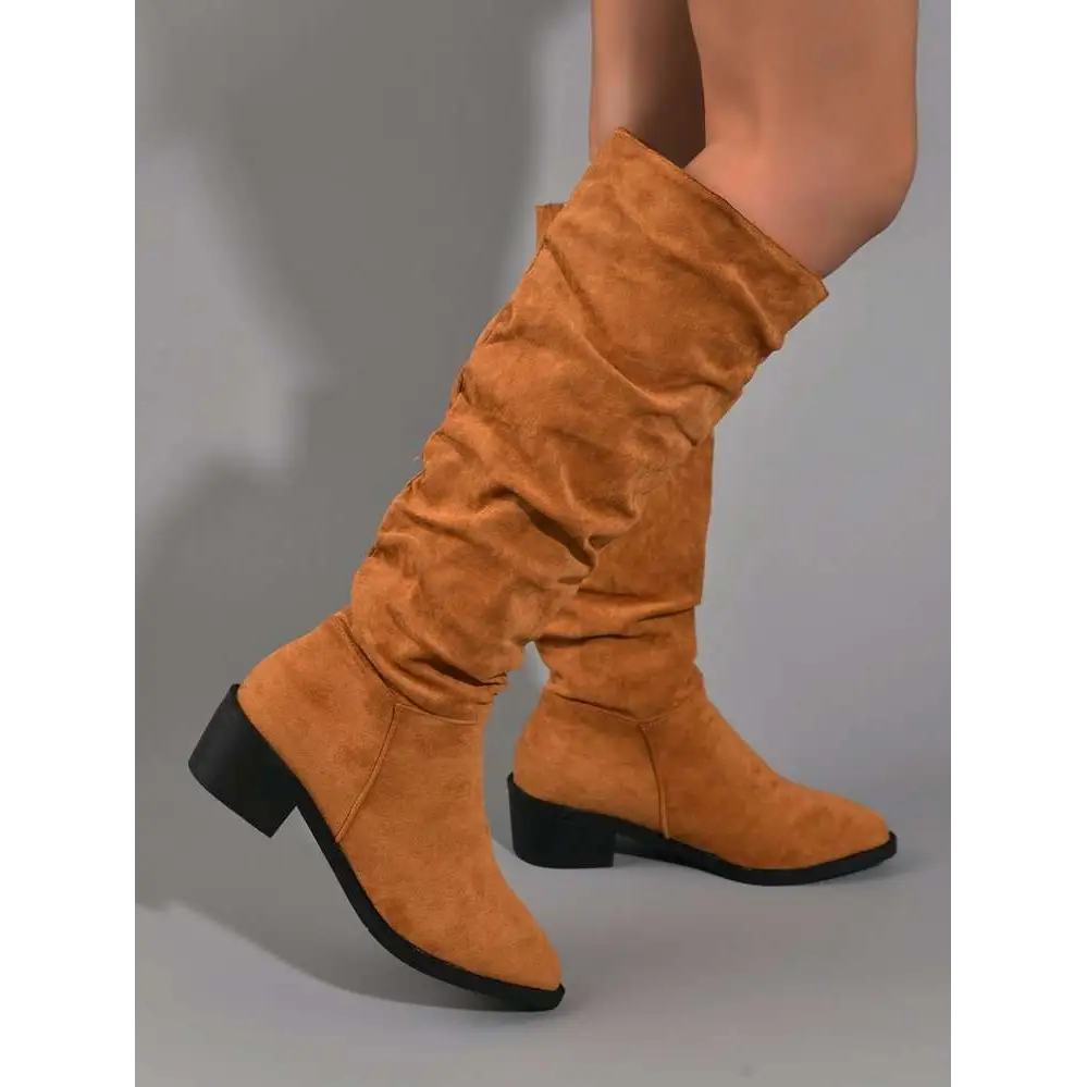 Tan slouchy sleeve suede high leg boot in tan with a ruched upper and black block heel knee-high design