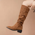 Tan slouchy sleeve suede high leg boot in tan with knee-high design low block heel and black sole