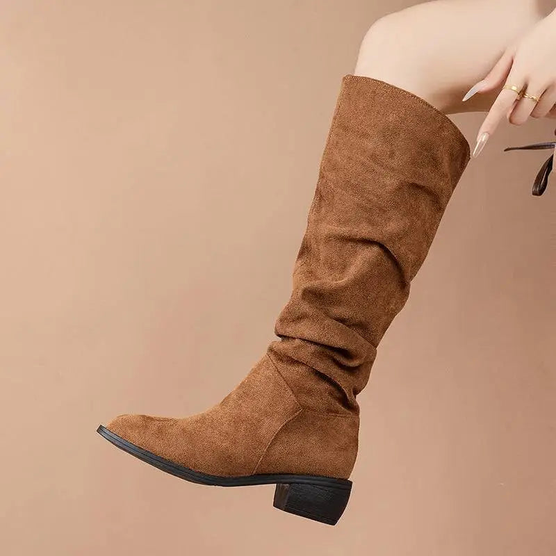 Tan slouchy sleeve suede high leg boot in tan with knee-high design low block heel and black sole