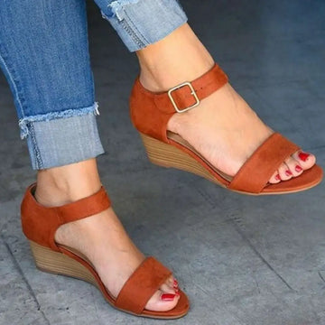 Tan suede wedge buckle strap plus size sandals featuring a wooden-textured heel and gold-toned buckle closure